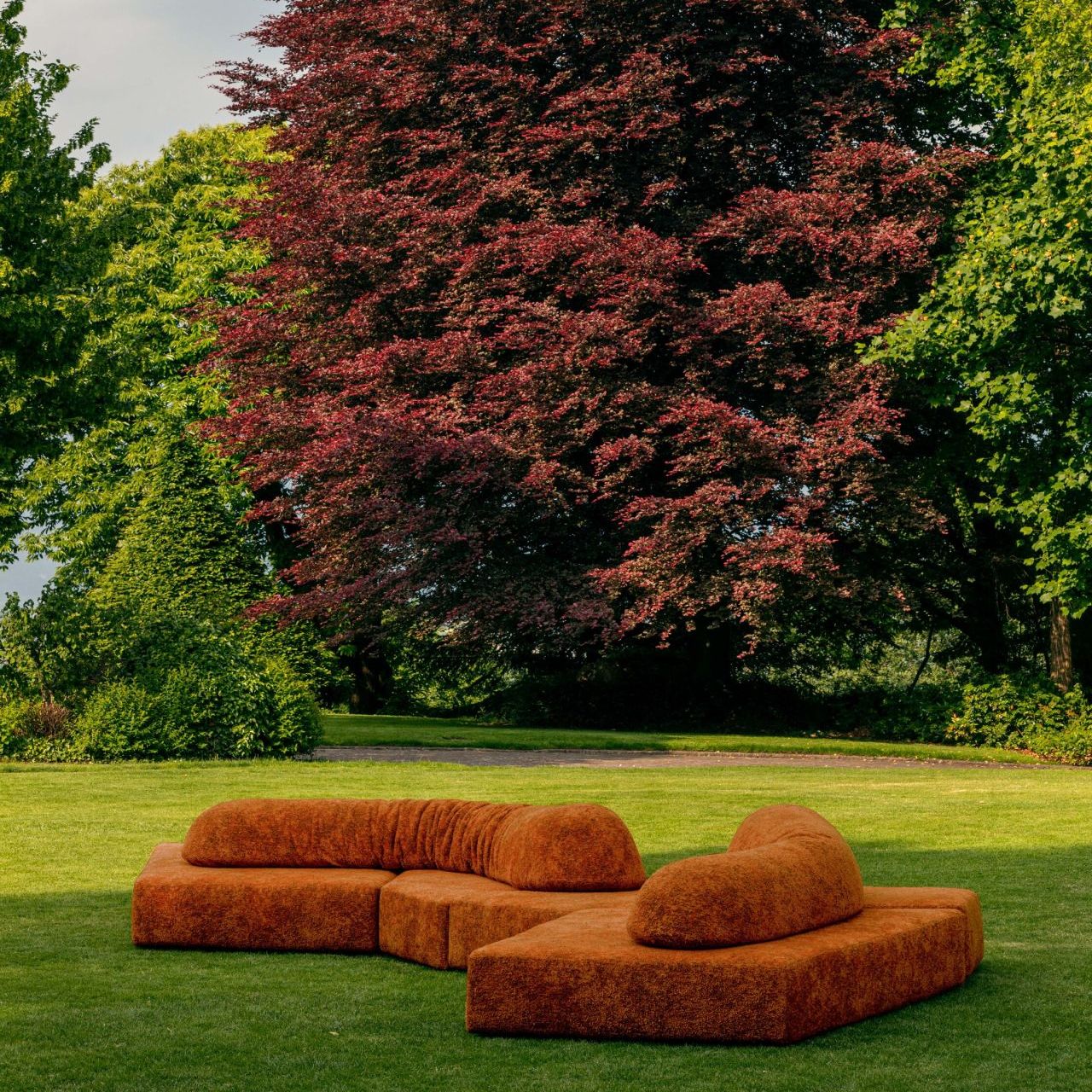  On the Rocks Outdoor 
upholstered in Every Stone Imperial Red in the garden overlooking Iseo Lake. 